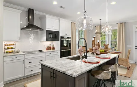 Kitchen with Leathered Granite Tops and Black Stainless Appliances