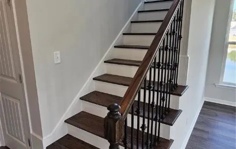 Wood Steps with Iron Balusters Downstairs