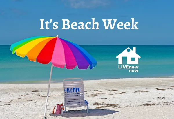 rainbow color beach umbrella beach chair on sandy beach with blue ocean