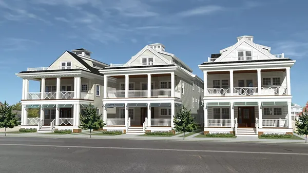 Photo of three, 3-story white duplex homes with front decks and porches
