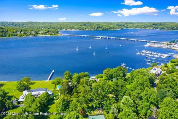 aerial view of Navesink river, Oceanic Bridge, Hartshorne Woods with boats on river, marina