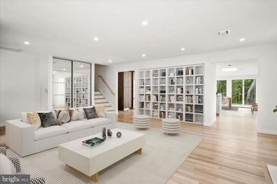 neutral white and light hardwood floor living room with built in bookcase