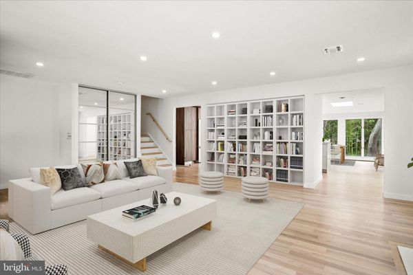 neutral white and light hardwood floor living room with built in bookcase