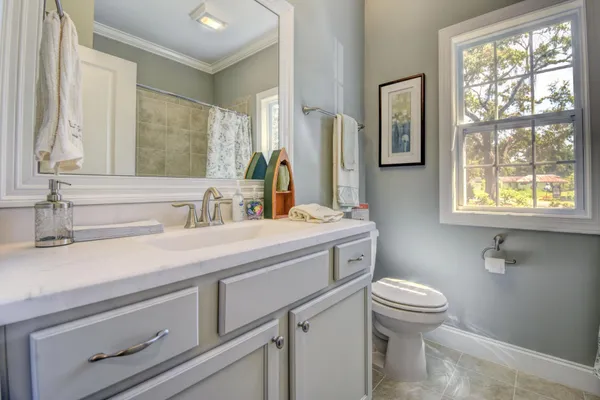 Powder room with framed mirror in a new home in Hampstead NC