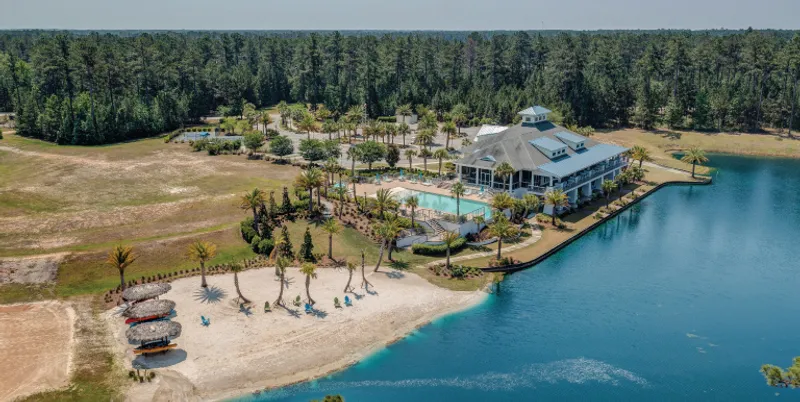Aerial image of a clubhouse and beach in a Logan Homes' community.