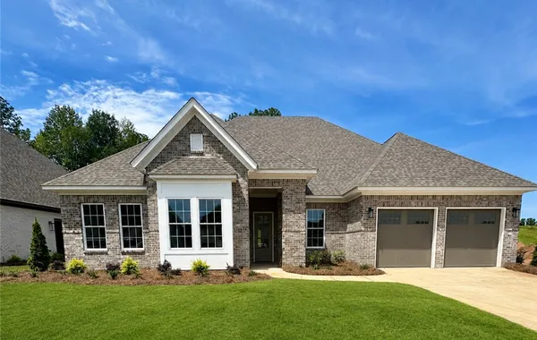 Symmetrical gables and detailed brickwork define the exterior of this modern single-family home.