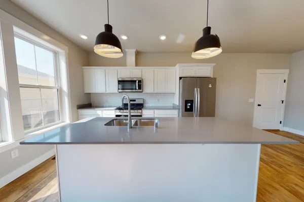 kitchen with an island in a new construction townhome by mccall homes