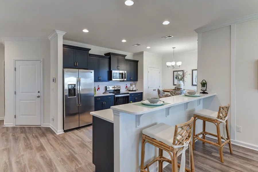 Kitchen with dark blue cabinets and white countertops in new construction home by Mungo Homes