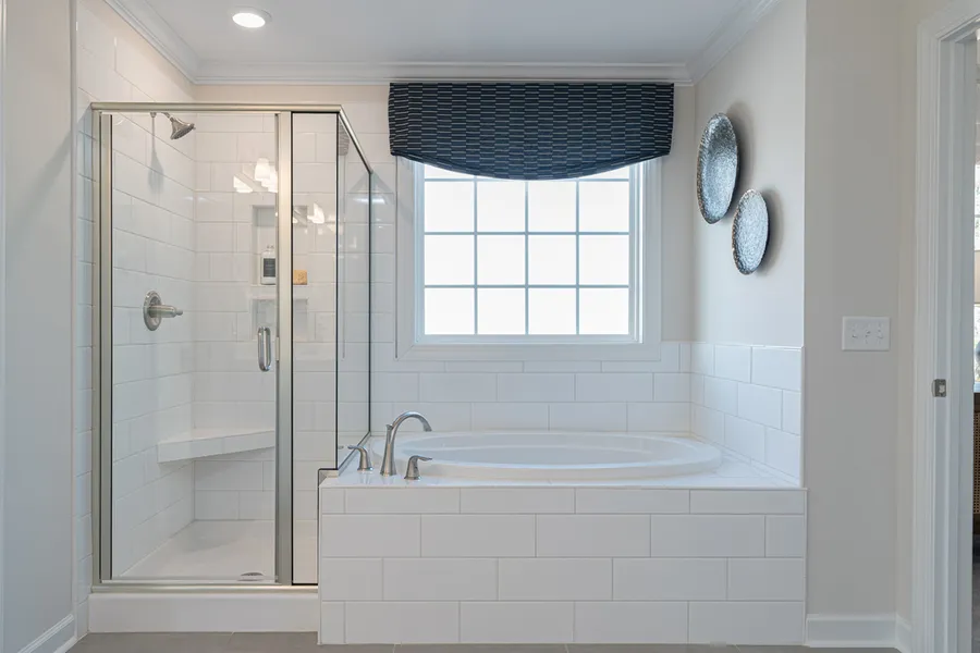 Garden tub & walk-in shower in primary bathroom new construction home by Mungo Homes