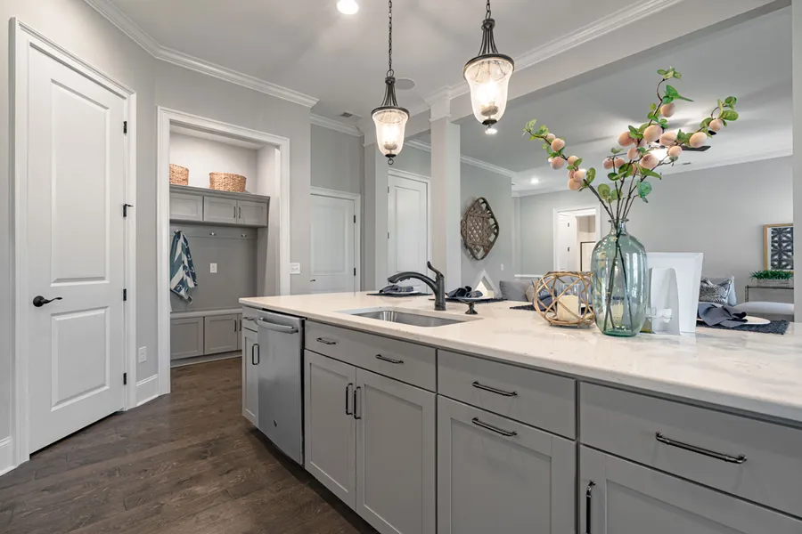 Grey cabinets and white subway tiles in new construction home by Mungo Homes