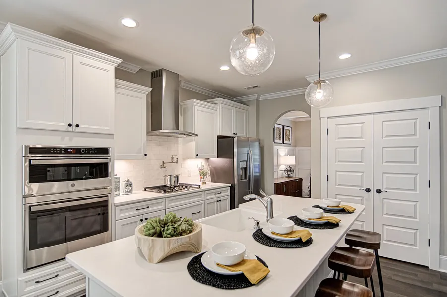 Open concept kitchen with big island in new construction home by Mungo Homes