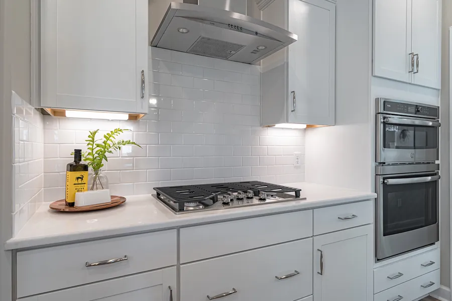 Bright white kitchen with gas cooktop in new construction Mungo Home