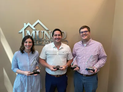 Mungo Homes employees holding Charleston Homebuilder's Association PRISM Awards