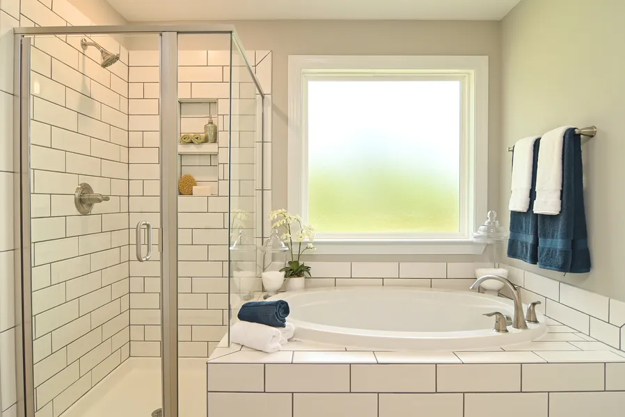 Garden tub & walk-in shower in primary bathroom new construction home by Mungo Homes