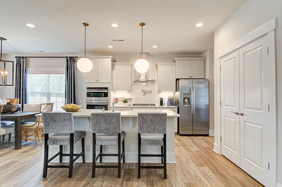Open concept kitchen with big island in new construction home by Mungo Homes