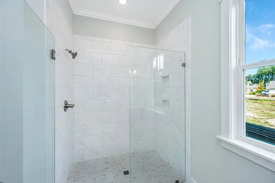 Walk-in shower in primary bathroom new construction home by Mungo Homes