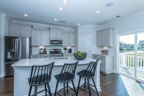 Grey cabinets in kitchen with open concept in new home in james island sc