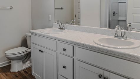 interior photo of all white master bathroom with double sink vanity