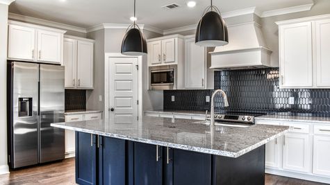 Interior photo of a wilson floorplan kitchen with upgraded vent hood package