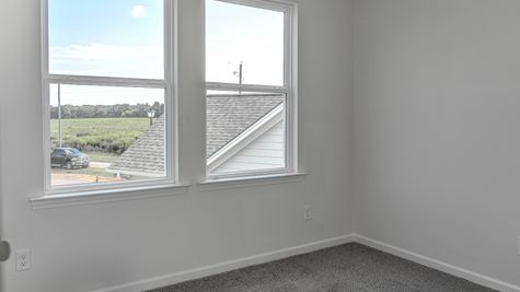 interior photo of bedroom with large window view