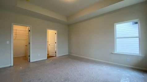 interior photo of master bedroom with vaulted ceilings
