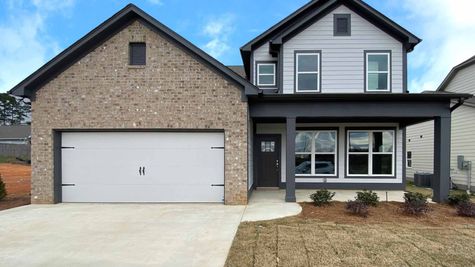 Exterior photo of 2 level home with half brick and vinyl with dark accents