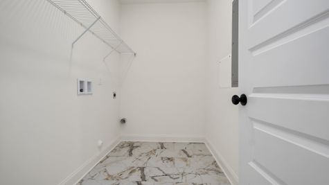 Interior view of laundry room with tile floors