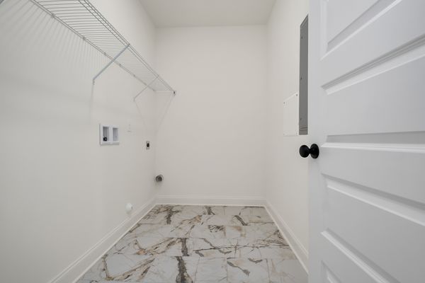 Interior view of laundry room with tile floors