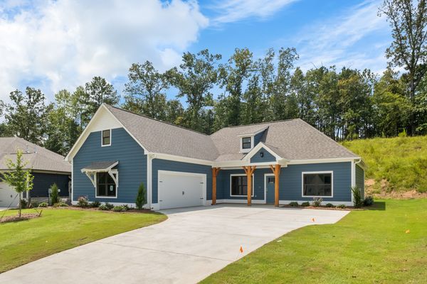 Exterior photo of a Bragg floorplan with blue siding, cedar accents, and a blue front door