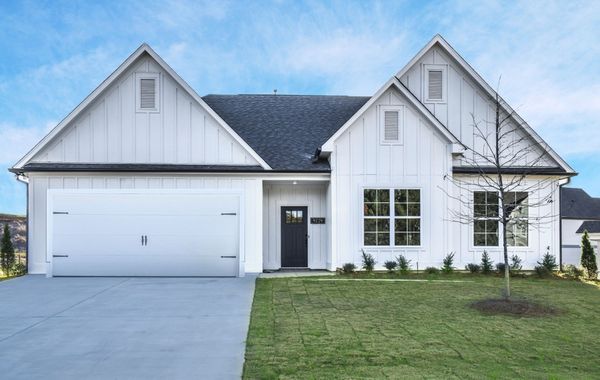 Exterior view of white home with dark trim & accents