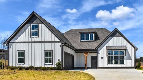 Exterior photo of a Belle Floorplan with white siding and dark accents