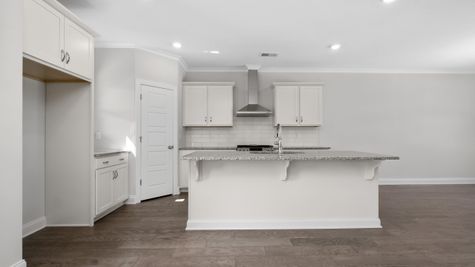Interior view of kitchen with white cabinets