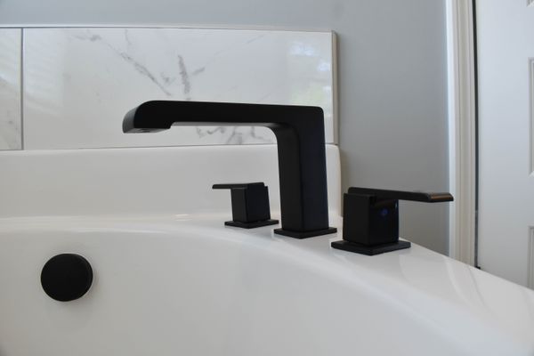 Angled view of a black bathtub faucet