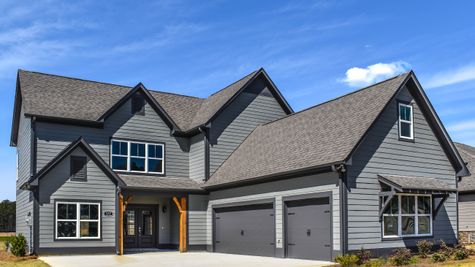 Exterior photo of 2 story Stockmore floorplan with dark gray siding, peppercorn trim, and a peppercorn front door