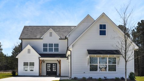 Exterior view of stockmore floorplan with white siding and black front door