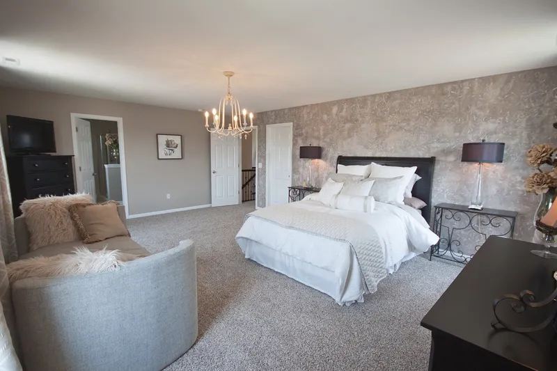 master bedroom in a new villa home in cedar lake indiana by olthof homes