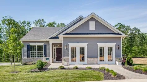 The exterior of the Zinnia model new home and sales office at Whitehall Gardens in Williamstown, NJ, a 55+ active adult community.