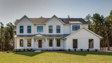 A beautiful farmhouse style house with black trim windows and front door in South Jersey