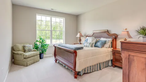 Primrose Master Bedroom with windows, carpet, sample furniture.
