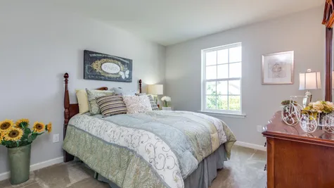 Bedroom in the Laurelton with sample furniture, carpet, window