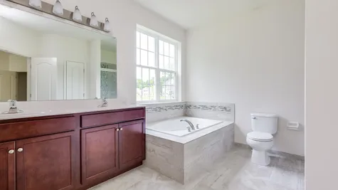 Augusta master bathroom with double sink and soaking tub