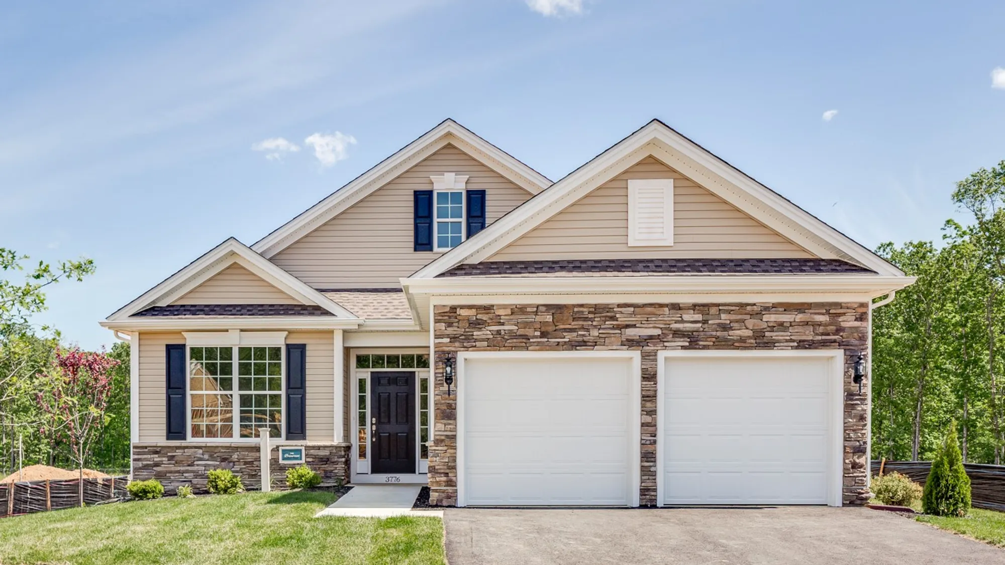 One-story active adult new homes with tan vinyl siding and brick exterior in South Jersey