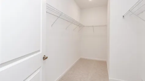 Walk in closet with wire racks.