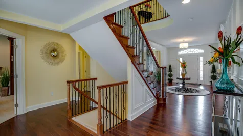 Stairs with decorative handrails in Brandywine model new home plus sample decor visible.
