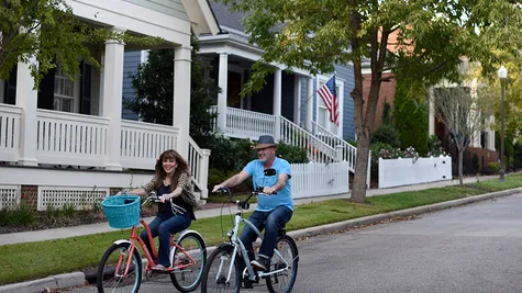 The Village of Providence couple riding bikes in neighborhood Huntsville AL