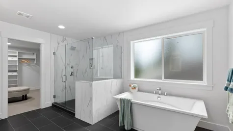 primary bathroom with walk-in shower and soaking tub