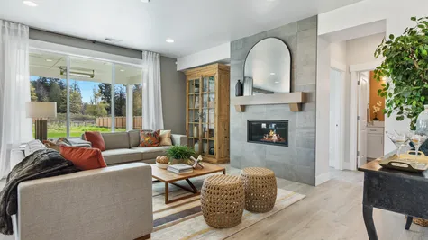 Great room anchored by fireplace with ceiling-height tile