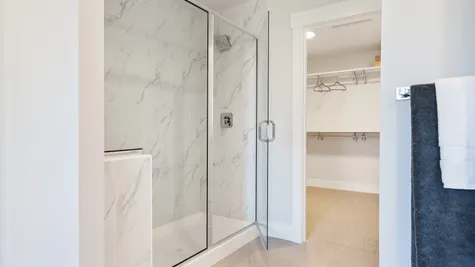 Big tiled shower and one of two walk-in closets