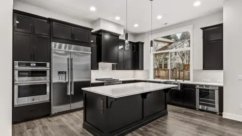 kitchen with rich dark wood cabinets, white countertops and jenn air rise appliances