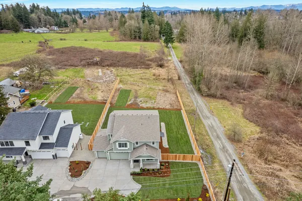 aerial shot of new home on third acre lot with fenced backyard